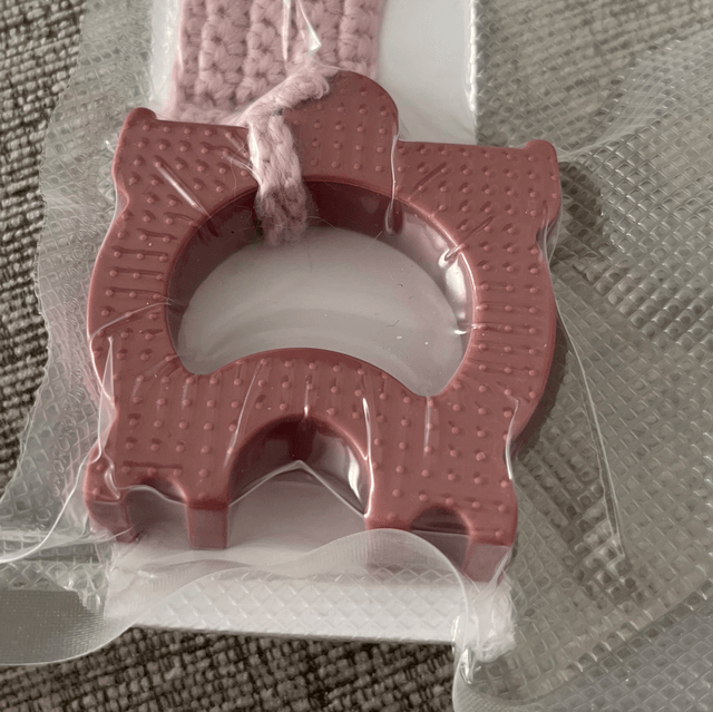 Dummy teething device with a crochet clip on strap