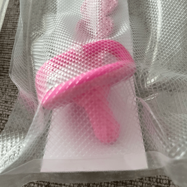 Dummy teething device with a crochet clip on strap