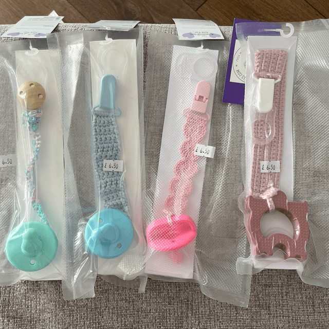 Dummy teething device with a crochet clip on strap